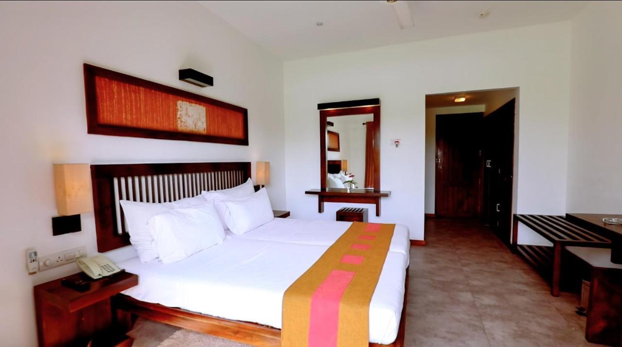 Deluxe Triple Room with a glass of traditional lassi overlooking paddy fields, and enjoy tea or coffee with evening snacks